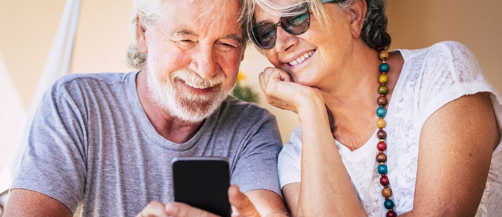 Older couple looking at a phone together